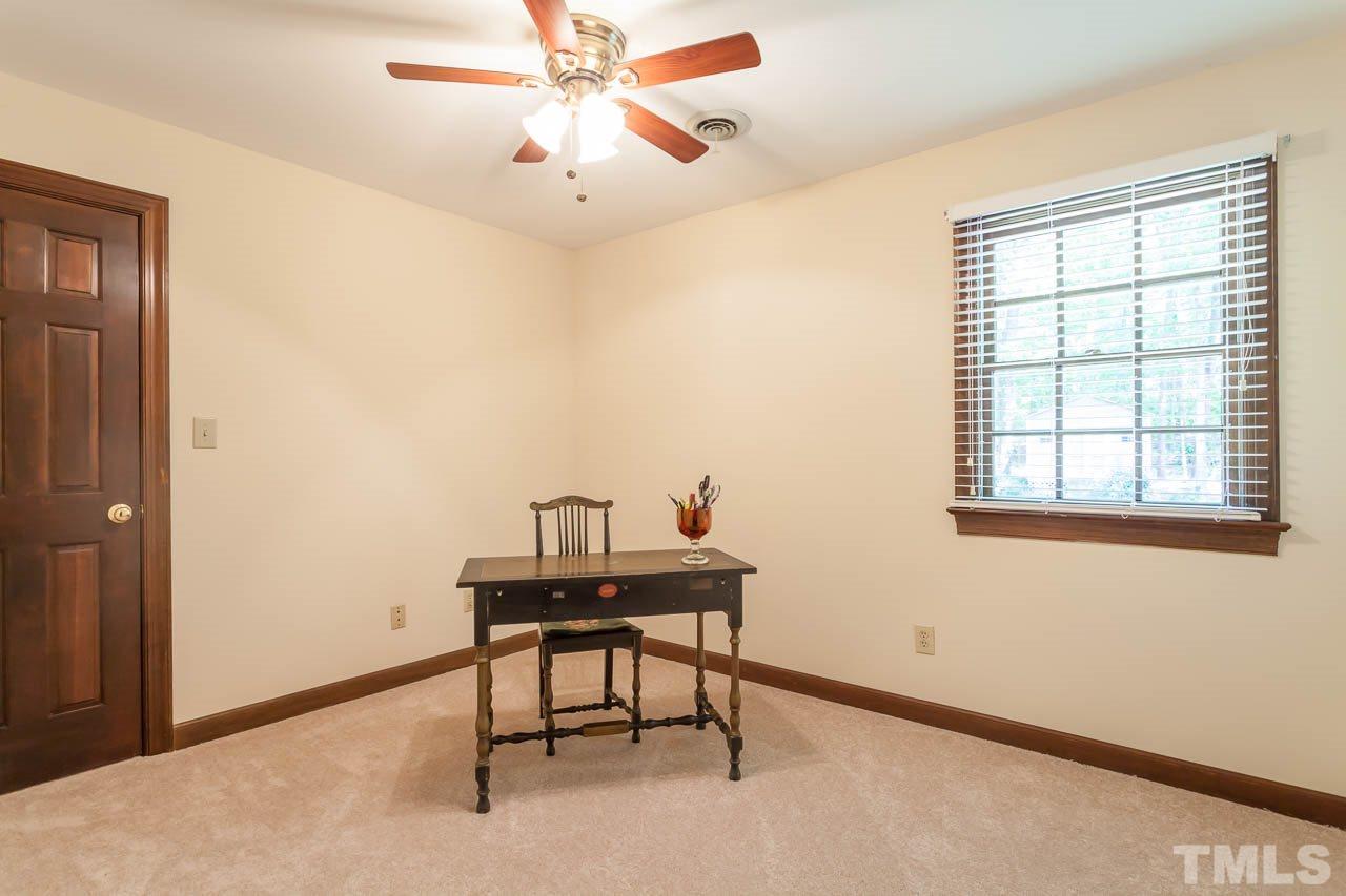 2901 Patrie Place Raleigh, NC 27613 - Photo 19 of 25 a workspace with chandelier fan and windows