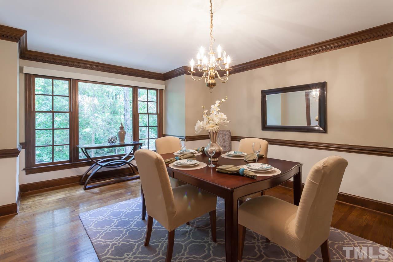 2901 Patrie Place Raleigh, NC 27613 - Photo 5 of 25 a dining room with furniture a large window and wooden floor