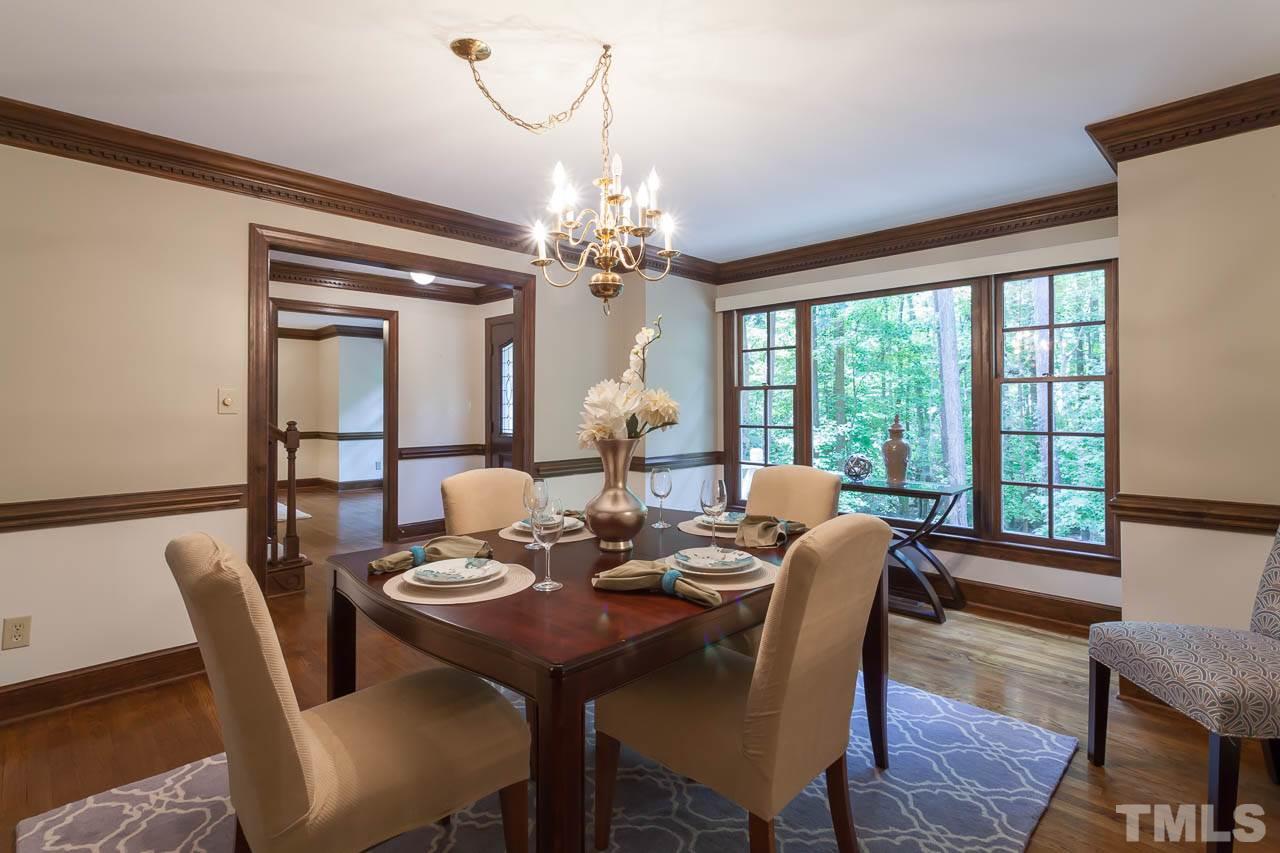 2901 Patrie Place Raleigh, NC 27613 - Photo 6 of 25 a view of a dining room with furniture a chandelier and wooden floor
