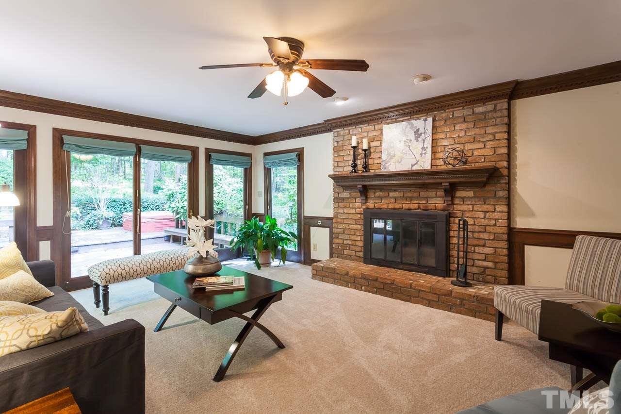 2901 Patrie Place Raleigh, NC 27613 - Photo 7 of 25 a living room with furniture a window and a fireplace
