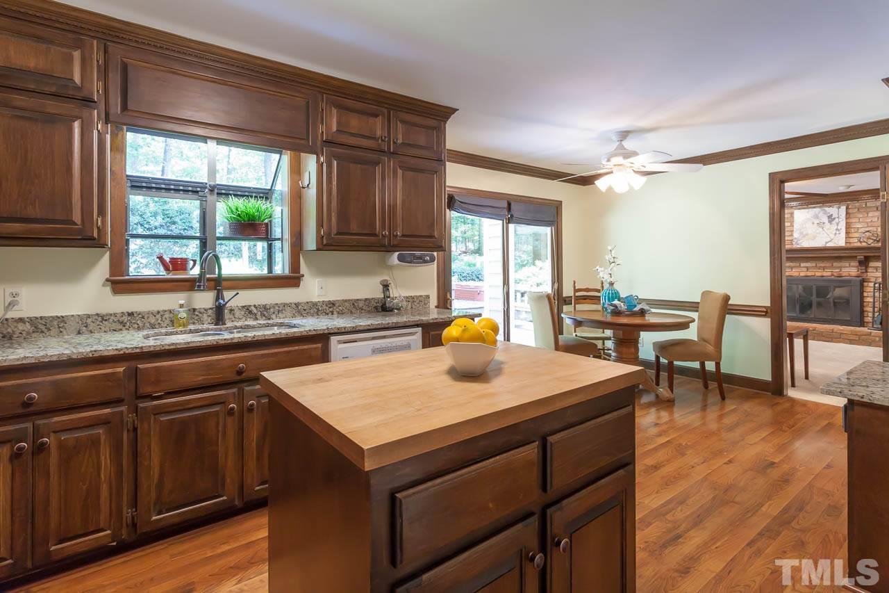 2901 Patrie Place Raleigh, NC 27613 - Photo 9 of 25 a kitchen with a sink a counter top space and living room