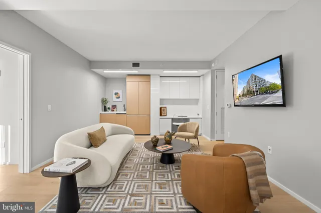 a living room filled with furniture windows and a table