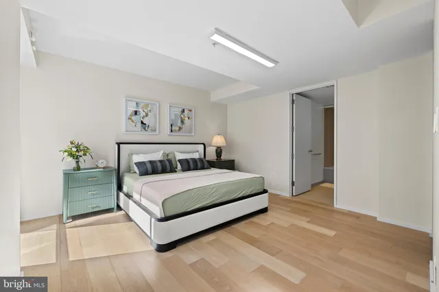 a view of a room with walk in closet and wooden floor