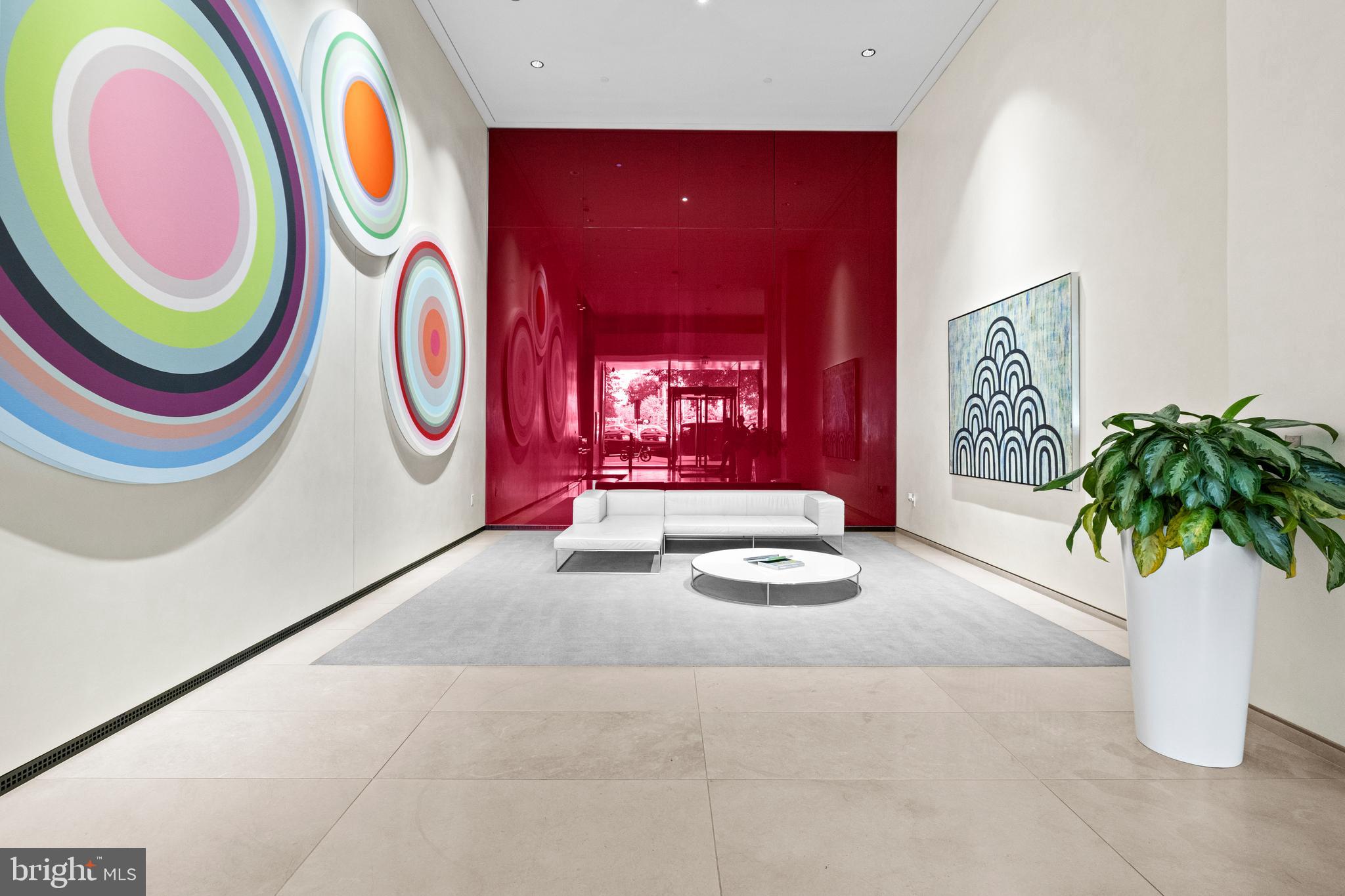 920 I Street Northwest, Unit 504505 Washington, DC 20001 - Photo 4 of 68 a living room with furniture and a potted plant
