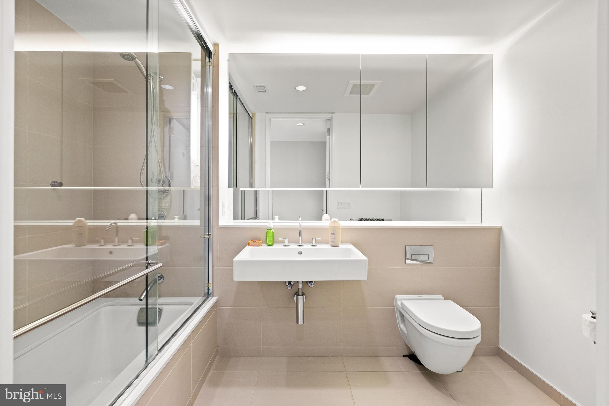 920 I Street Northwest, Unit 504505 Washington, DC 20001 - Photo 46 of 68 a bathroom with a toilet sink and mirror