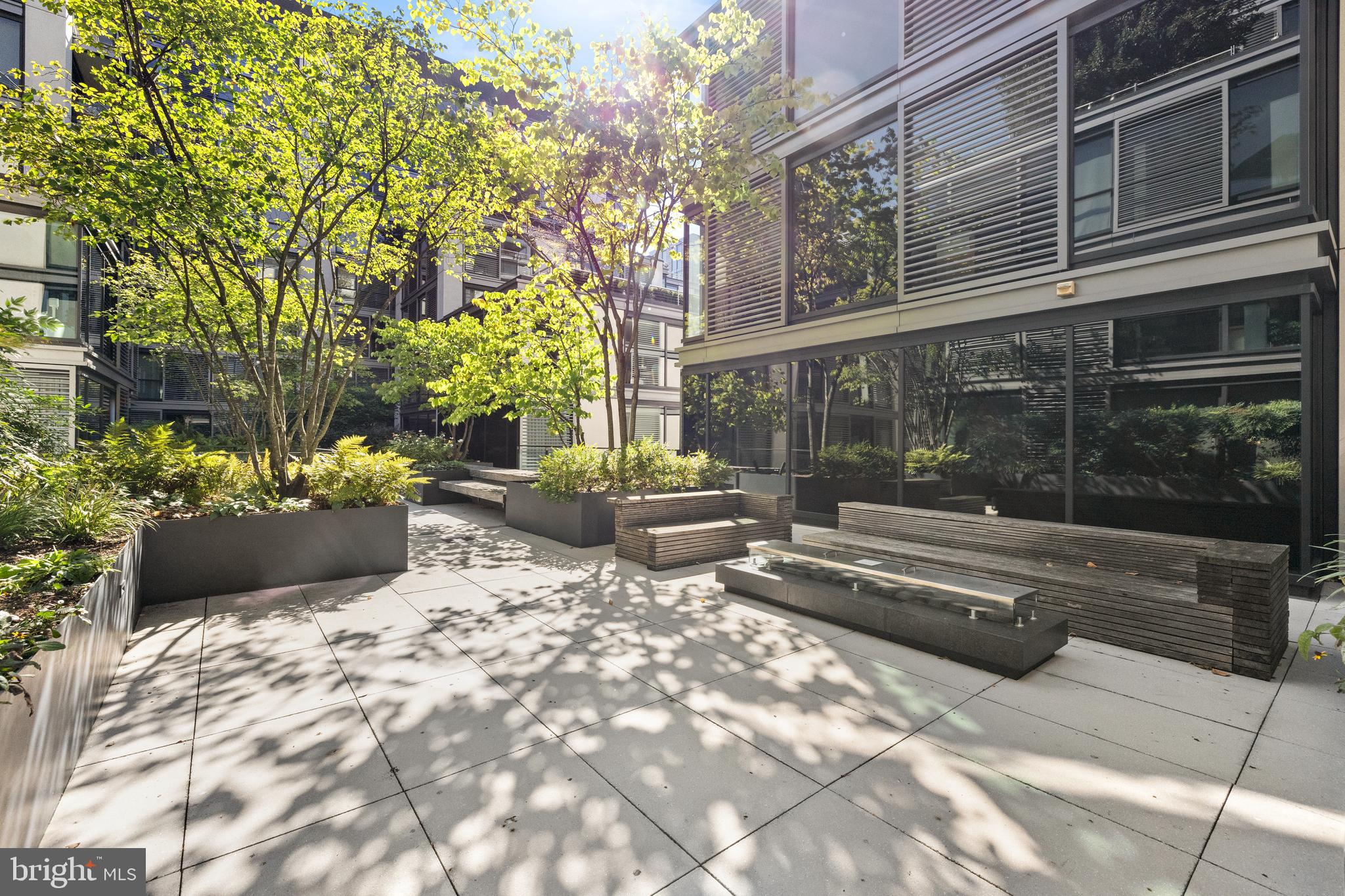 920 I Street Northwest, Unit 504505 Washington, DC 20001 - Photo 60 of 68 a view of a patio with table and chairs and potted plants