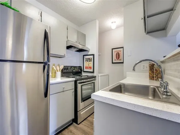 a kitchen with a refrigerator sink and stove