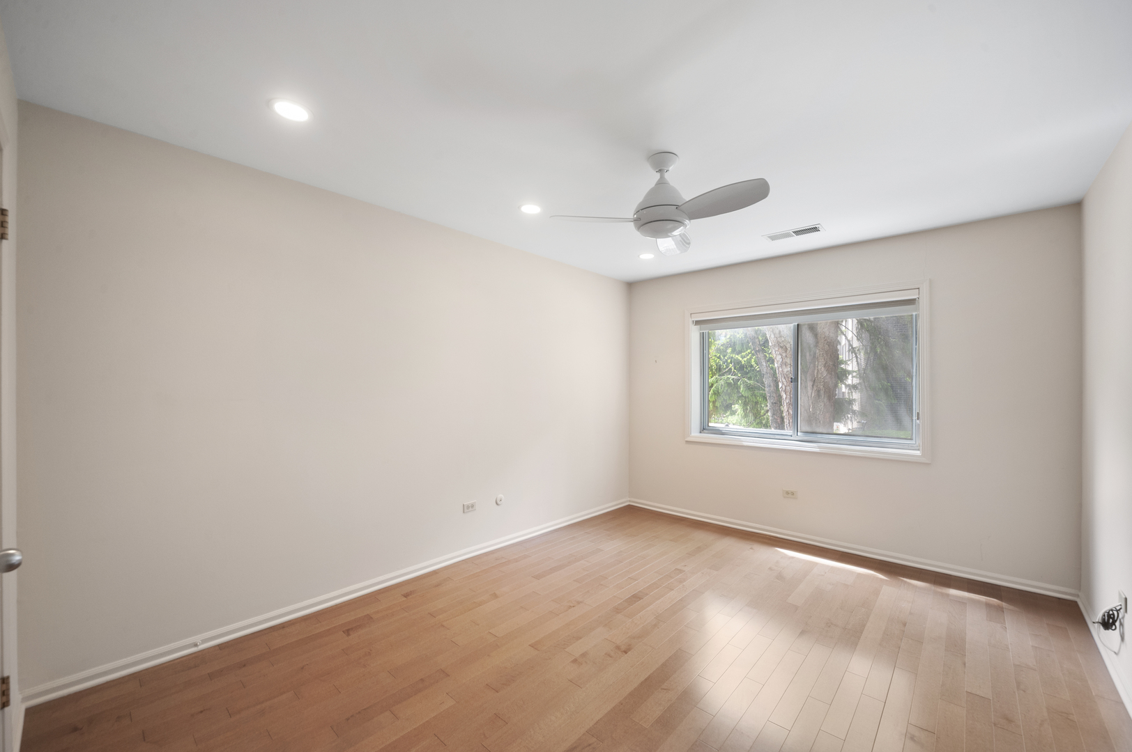 4949 Golf Road, Unit 101 Skokie, IL 60077 - Photo 15 of 22 wooden floor in an empty room with a window