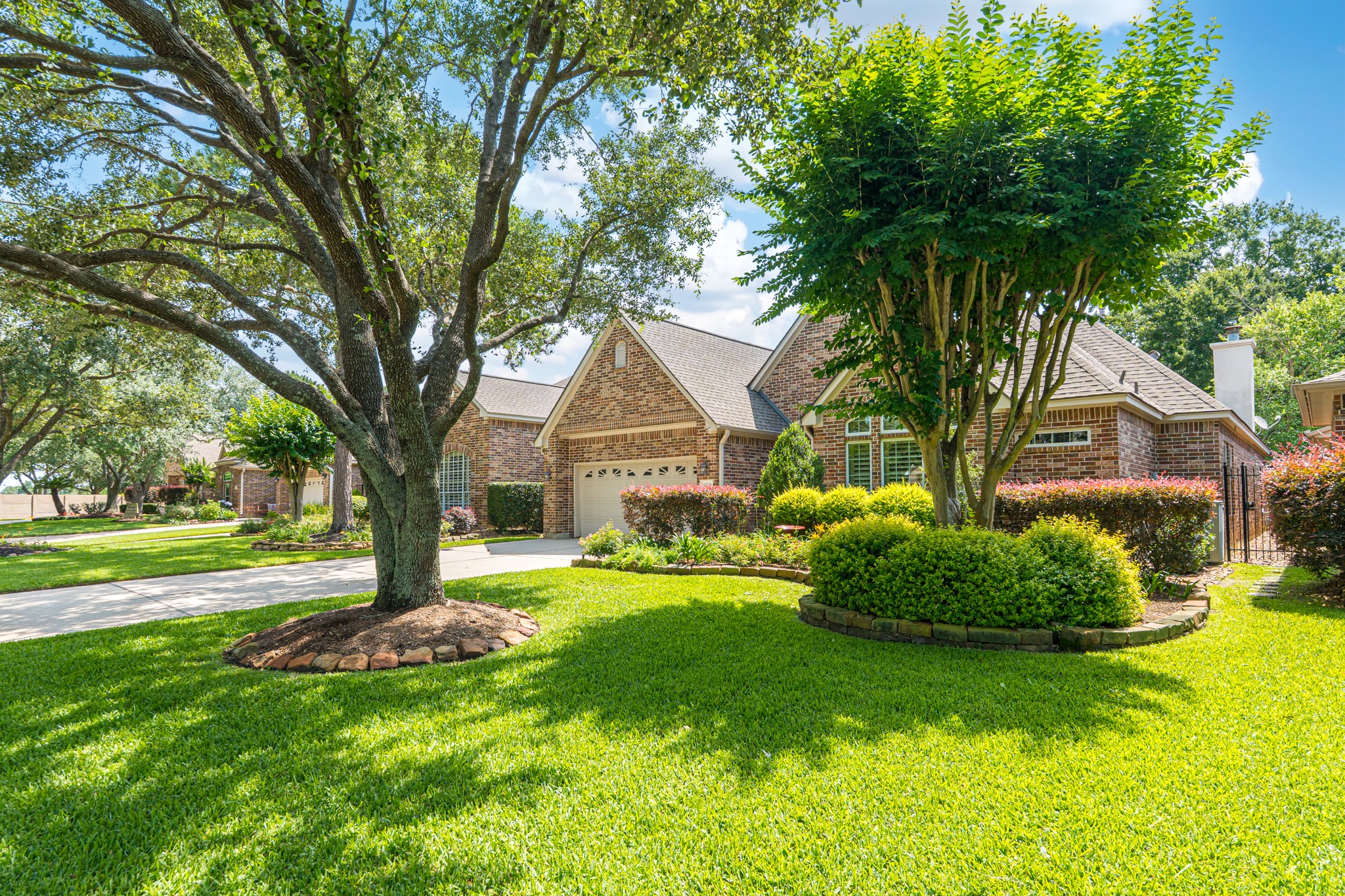 20714 Flora View Court Spring, TX 77379 - Photo 3 of 40 a front view of a house with a garden and trees