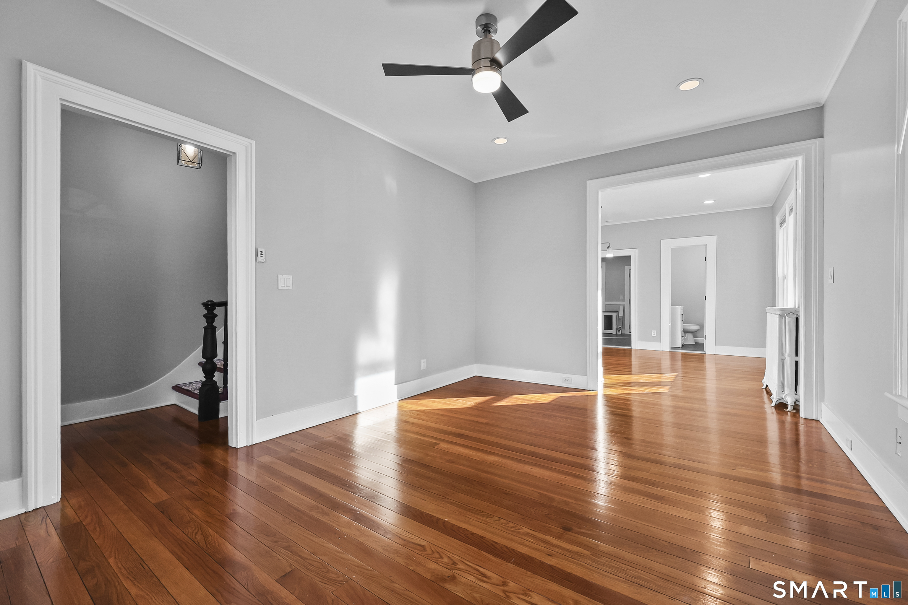 a view of empty room with wooden floor