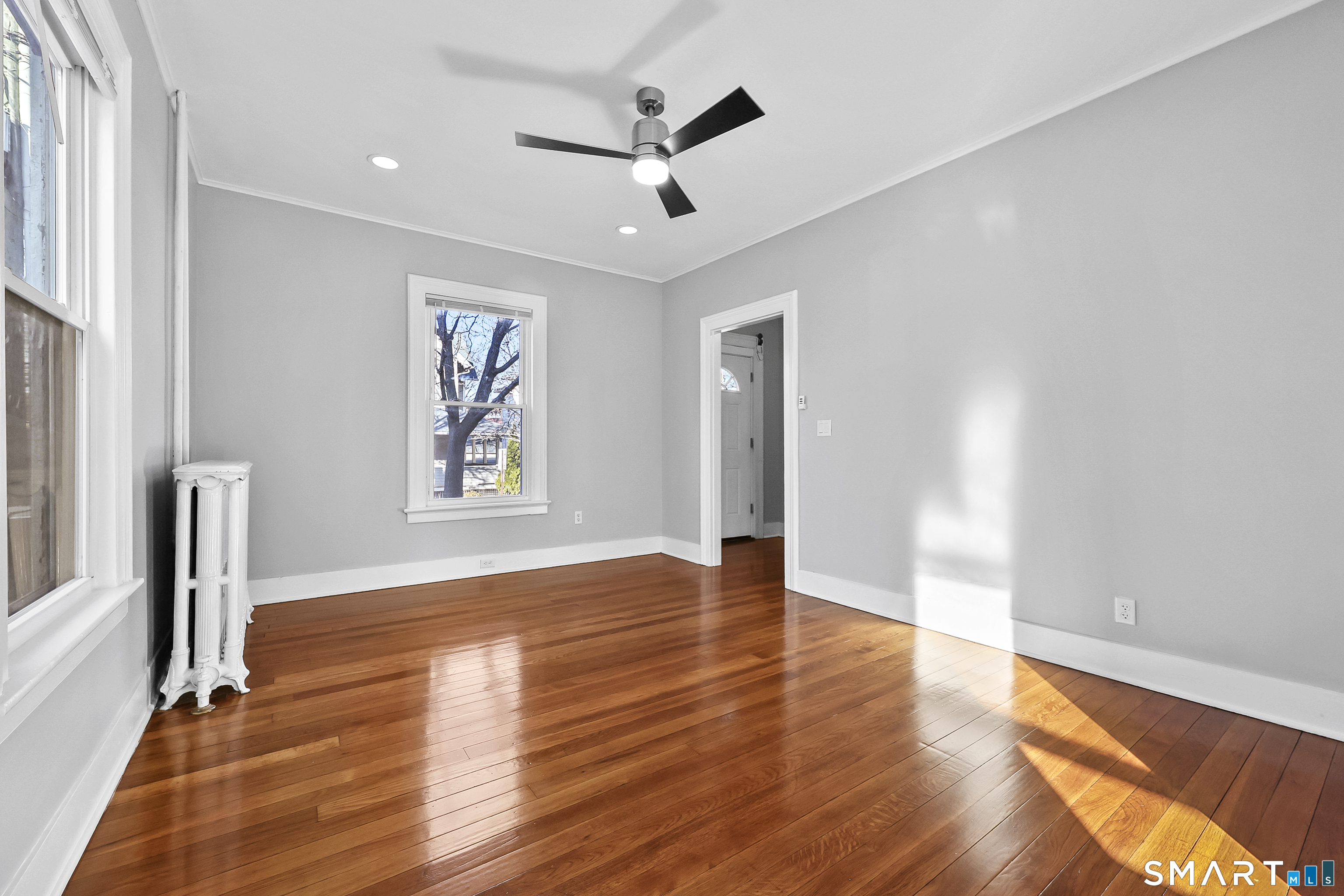 59 Grand Street Middletown, CT 06457 - Photo 11 of 33 a view of empty room with wooden floor and fan