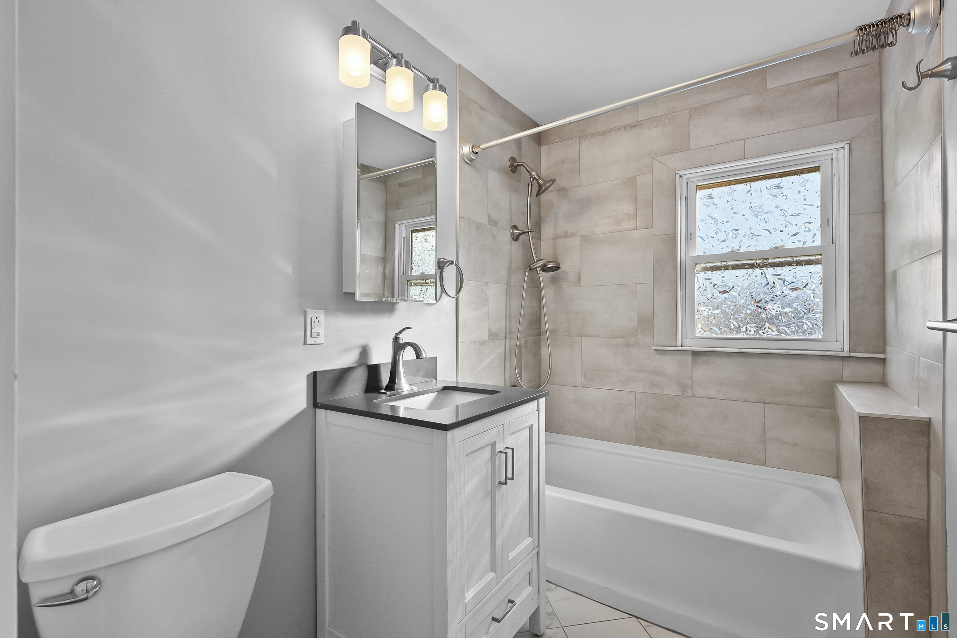 59 Grand Street Middletown, CT 06457 - Photo 15 of 33 a bathroom with a granite countertop sink a toilet and shower