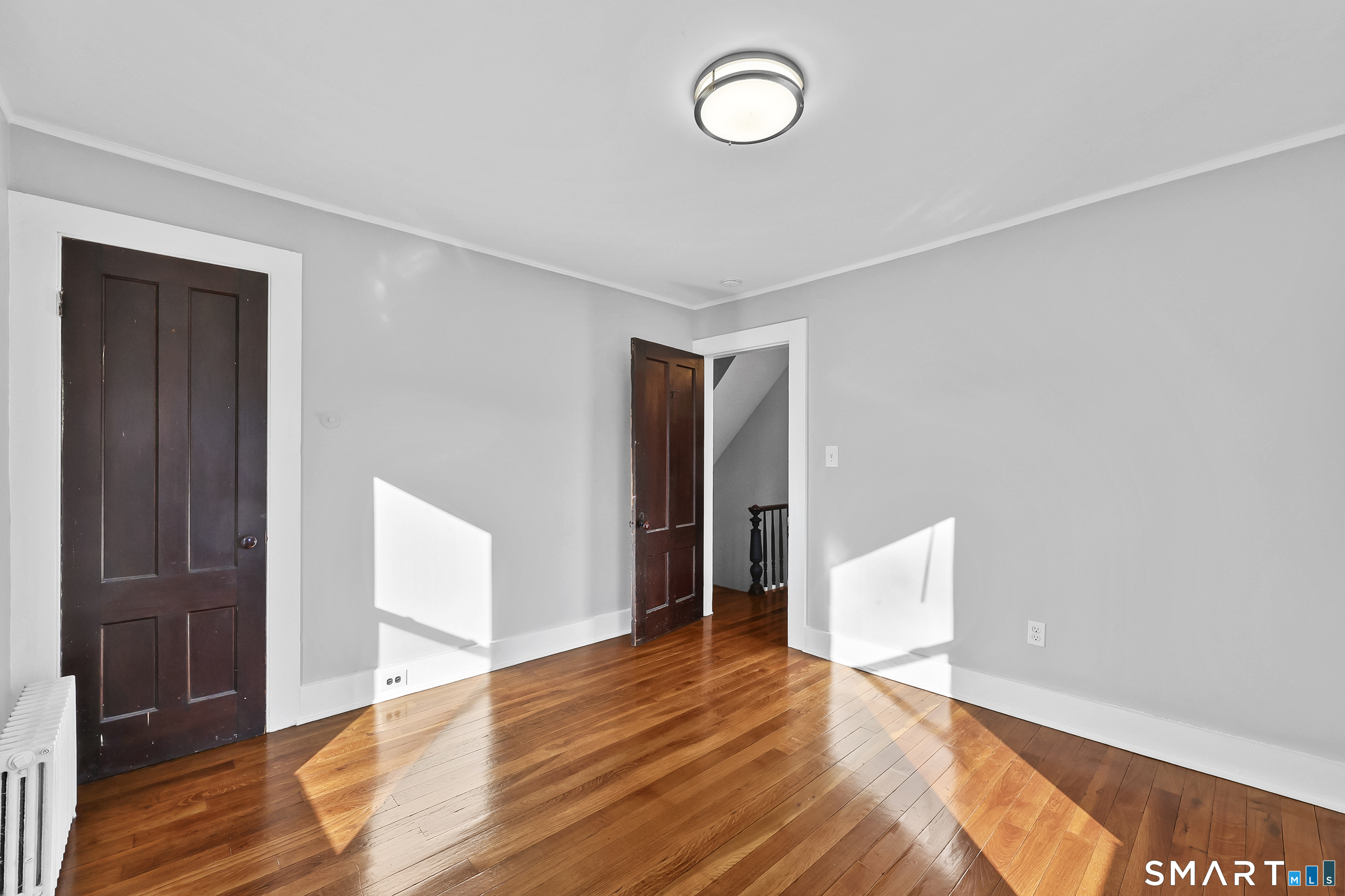 59 Grand Street Middletown, CT 06457 - Photo 17 of 33 a view of an empty room with wooden floor and closet