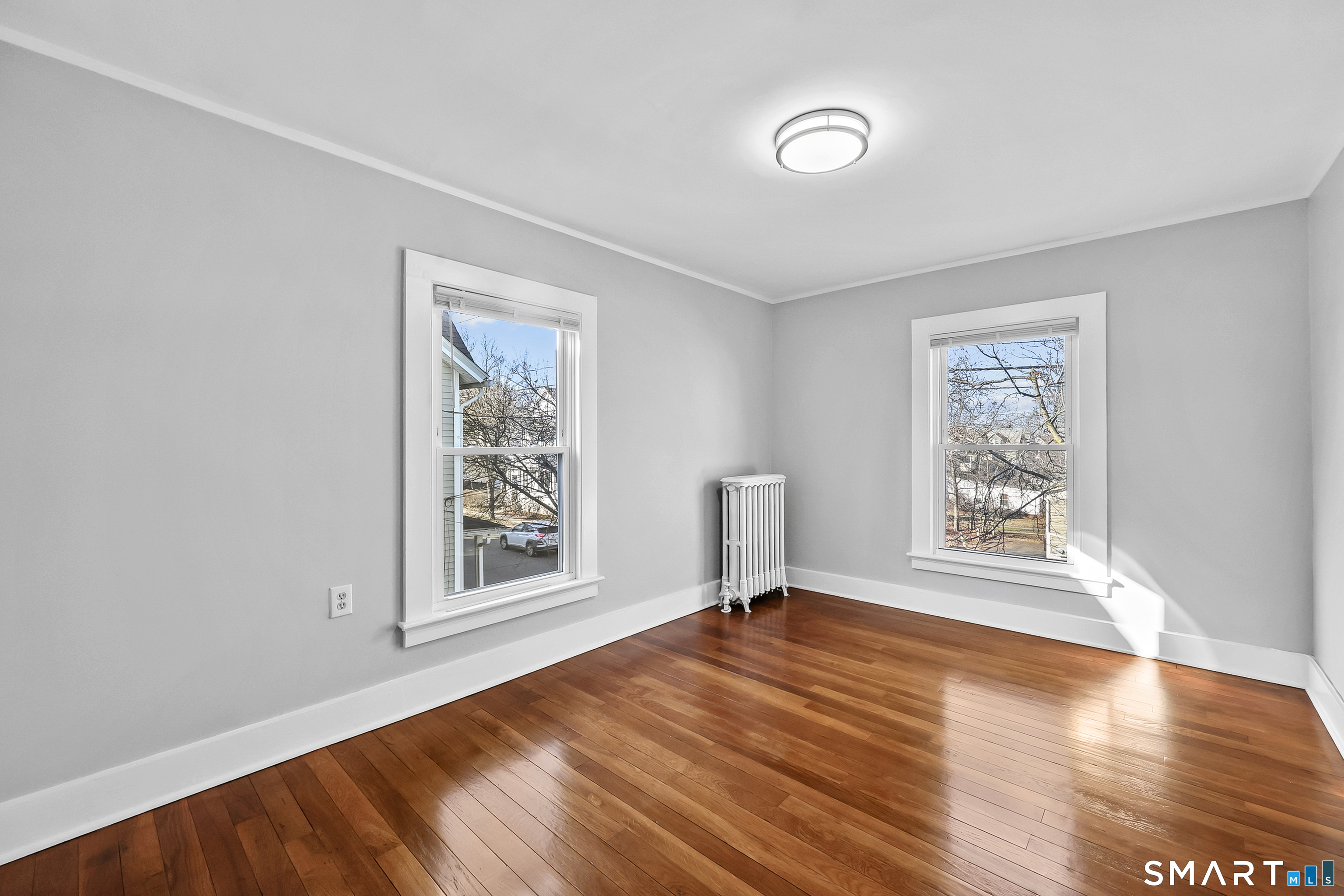 59 Grand Street Middletown, CT 06457 - Photo 18 of 33 a view of an empty room with window and wooden floor