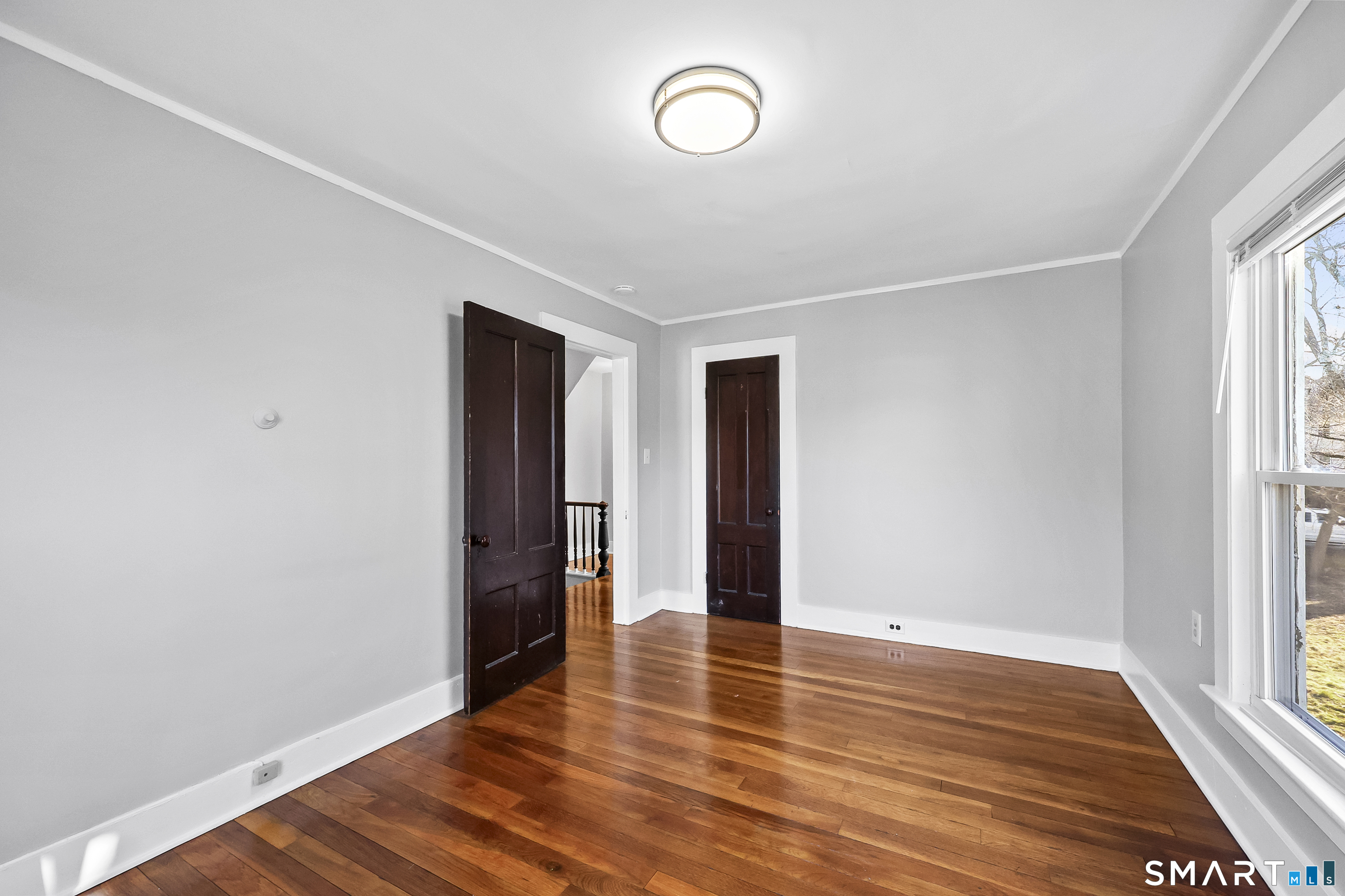 59 Grand Street Middletown, CT 06457 - Photo 19 of 33 a view of an empty room with wooden floor and a window