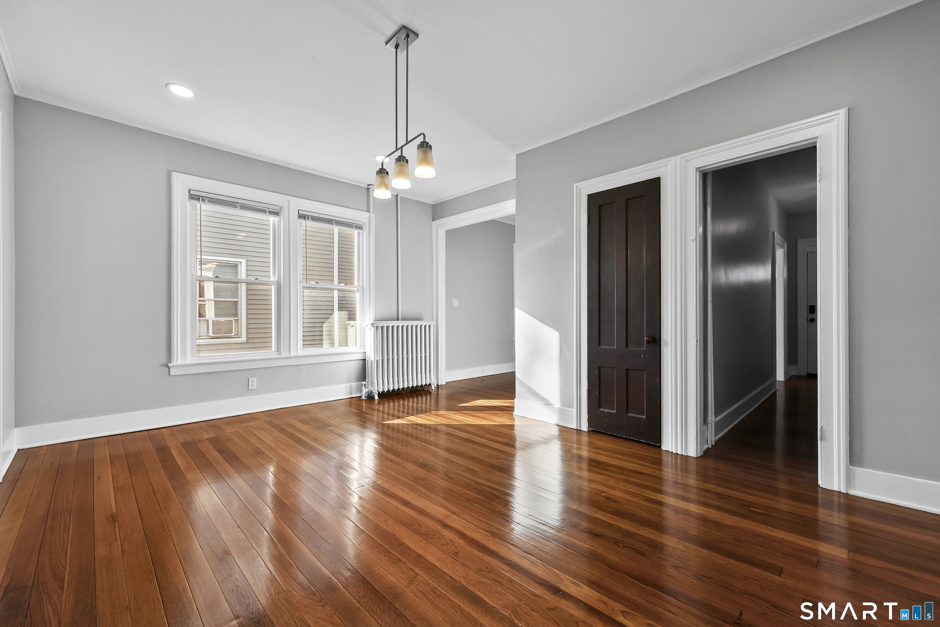 59 Grand Street Middletown, CT 06457 - Photo 7 of 33 a view of an empty room with window and wooden floor