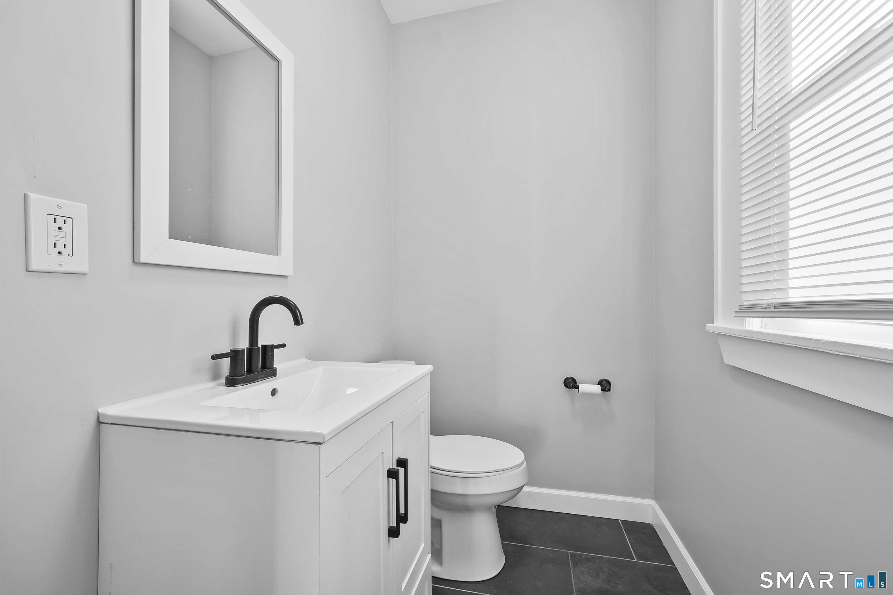 59 Grand Street Middletown, CT 06457 - Photo 9 of 33 a bathroom with a toilet sink and mirror