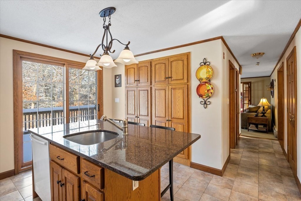 5 Sandy Lane Assonet, MA 02702 - Photo 15 of 34 a kitchen with stainless steel appliances granite countertop a sink a counter top space and living room view