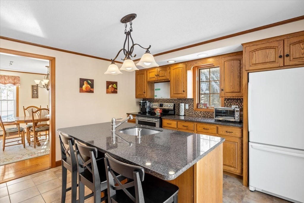 5 Sandy Lane Assonet, MA 02702 - Photo 16 of 34 a dining table with chairs and kitchen view