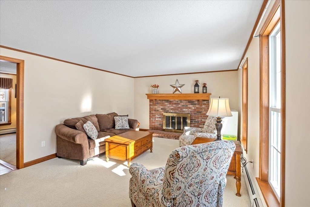 5 Sandy Lane Assonet, MA 02702 - Photo 23 of 34 a living room with furniture a fireplace and a large window