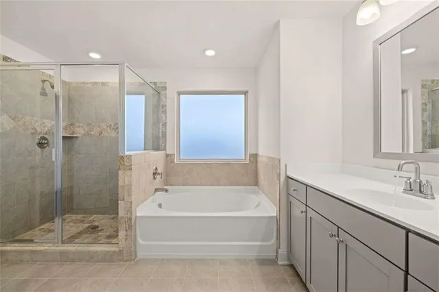 a white bath tub sitting next to a bathroom sink