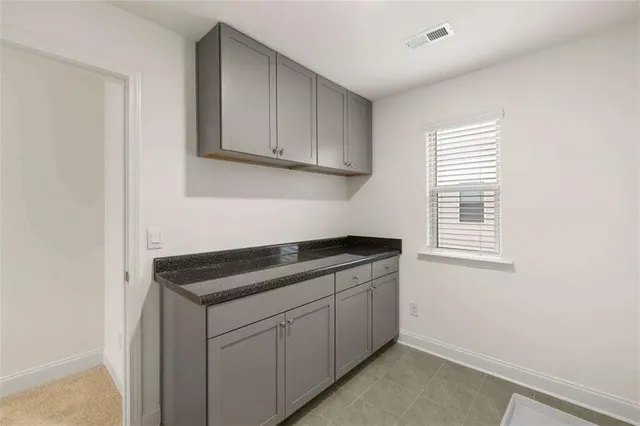 a kitchen with a sink cabinets and window
