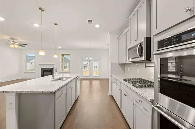a large kitchen with a stove and a sink