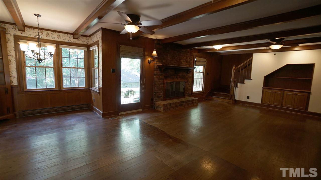 1421 Lynn Road Raleigh, NC 27612 - Photo 11 of 30 Open to kitchen, tongue and groove original oak hardwood floors in excellent condition, working wood fireplace w/ gas logs, built ins, and views of the private back yard
