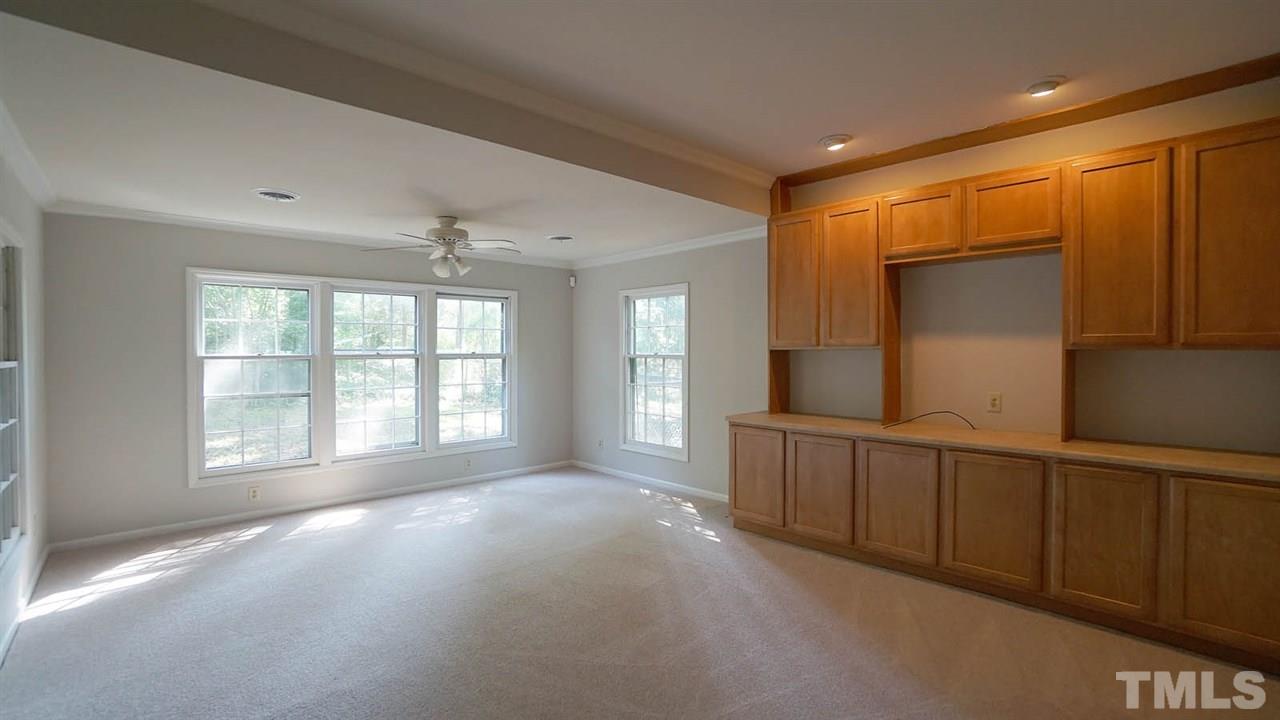 1421 Lynn Road Raleigh, NC 27612 - Photo 27 of 30 Family room, with brand new carpet & fresh paint, built ins and plenty of light.