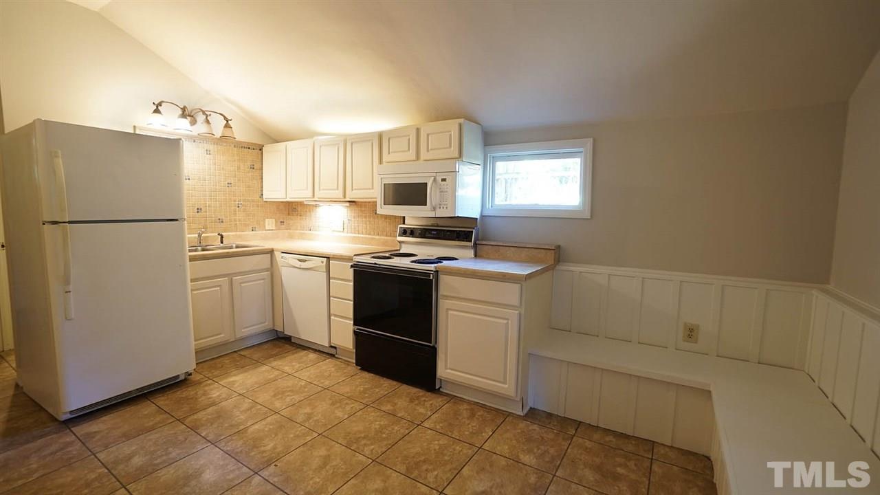1421 Lynn Road Raleigh, NC 27612 - Photo 28 of 30 Kitchen w/ stove, dishwasher, refrigerator and built in seating