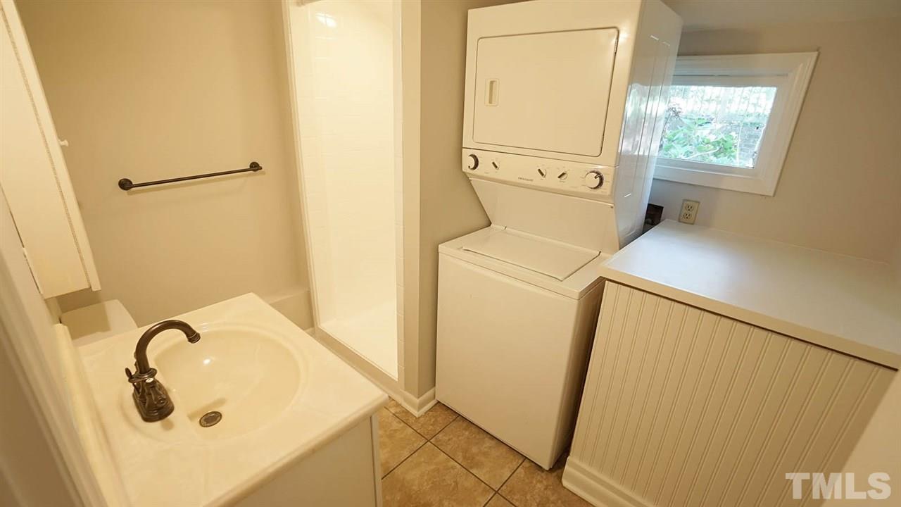 1421 Lynn Road Raleigh, NC 27612 - Photo 29 of 30 Bathroom w/ walk in shower that looks brand new. Includes stacked washer dryer