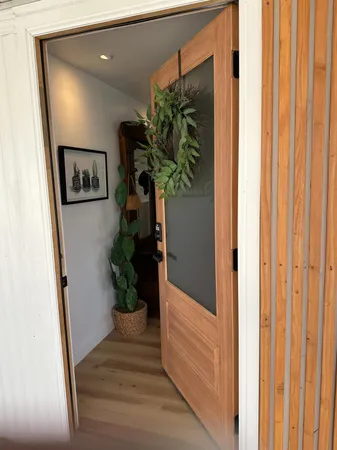 a view of a hallway with wooden floor and closet