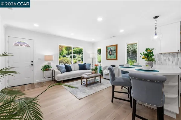 a living room with furniture wooden floor and window