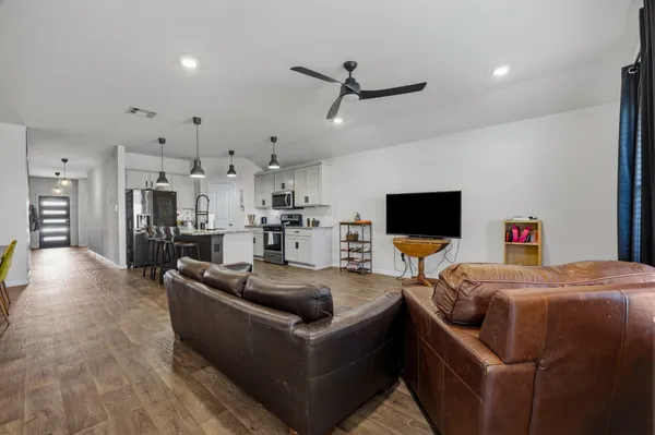 a view of a dining room with furniture and wooden floor