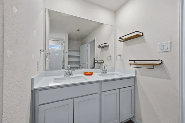 a bedroom with a bed and a ceiling fan