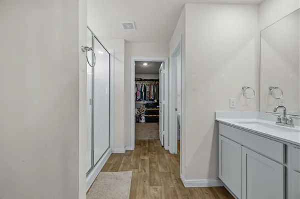 a large bed sitting in a bedroom next to a window