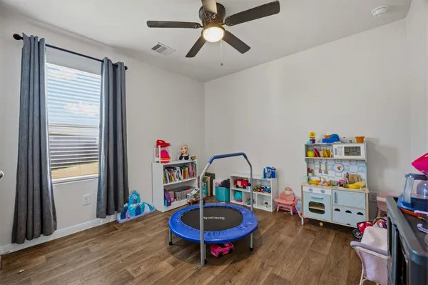 a view of a workspace with furniture and wooden floor