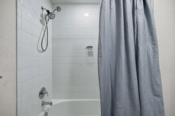 a living room with baby crib furniture and a window