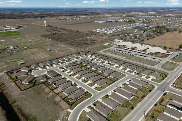 a view of a backyard with table and chairs and wooden fence