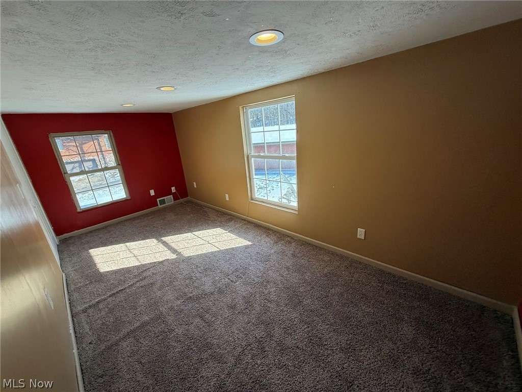 6784 Old Zoarville Road Northeast Dover, OH 44622 - Photo 26 of 50 Unfurnished room with carpet flooring and a textured ceiling