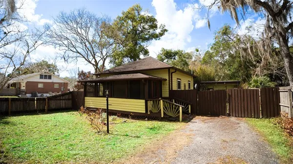 a view of a house with a yard and furniture