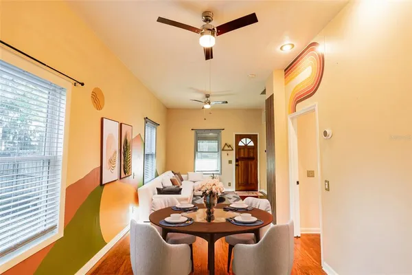 a view of a dining room with furniture and a chandelier