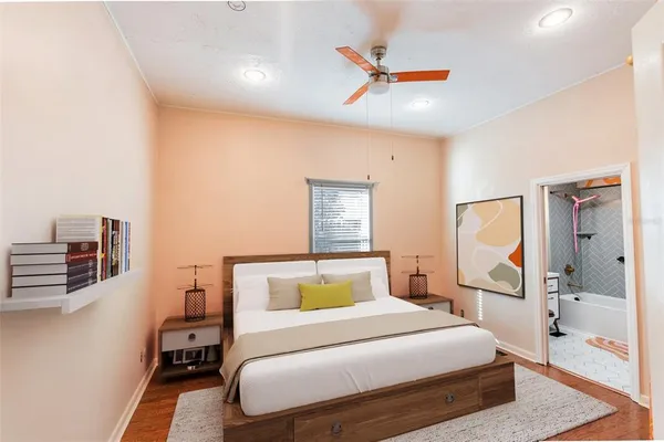 a bedroom with a bed and wooden floor