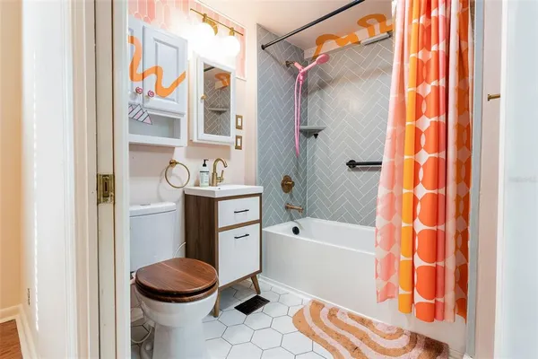 a bathroom with a sink toilet and shower
