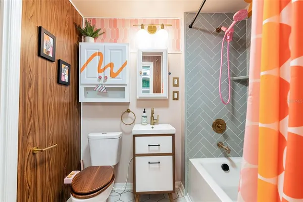 a bathroom with a sink toilet and shower