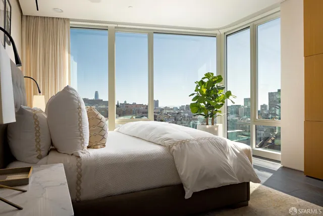 a bedroom with a bed and large window