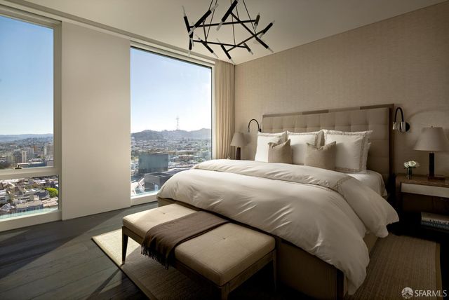 a bed sitting in a bedroom next to a window