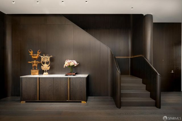 a view of entryway and hall with wooden floor