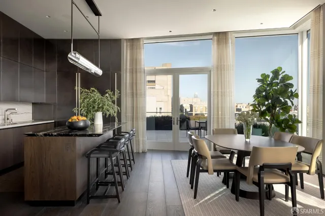 a dining room with furniture and potted plants