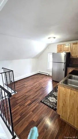a view of an empty room and wooden floor